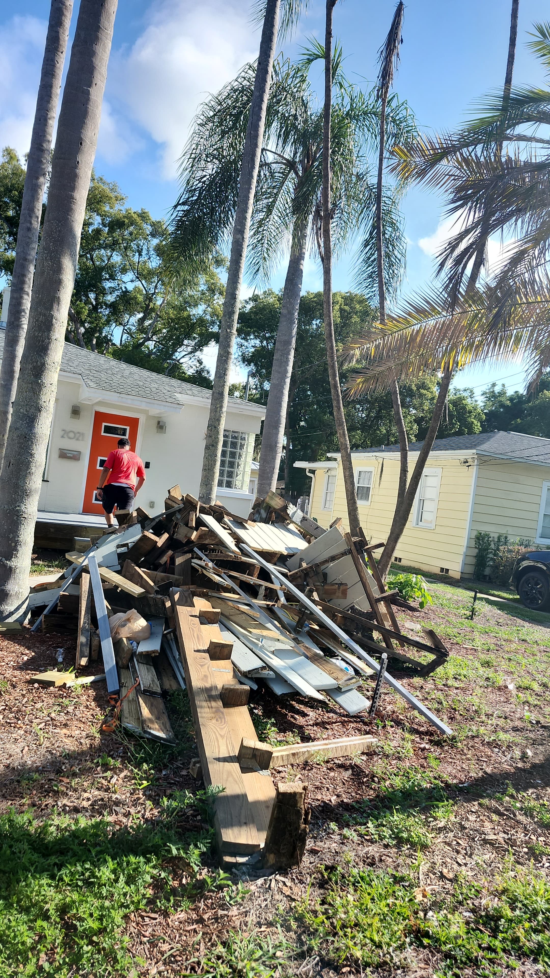Before: Another angle showing the scale of the deck debris pile with crew member approaching