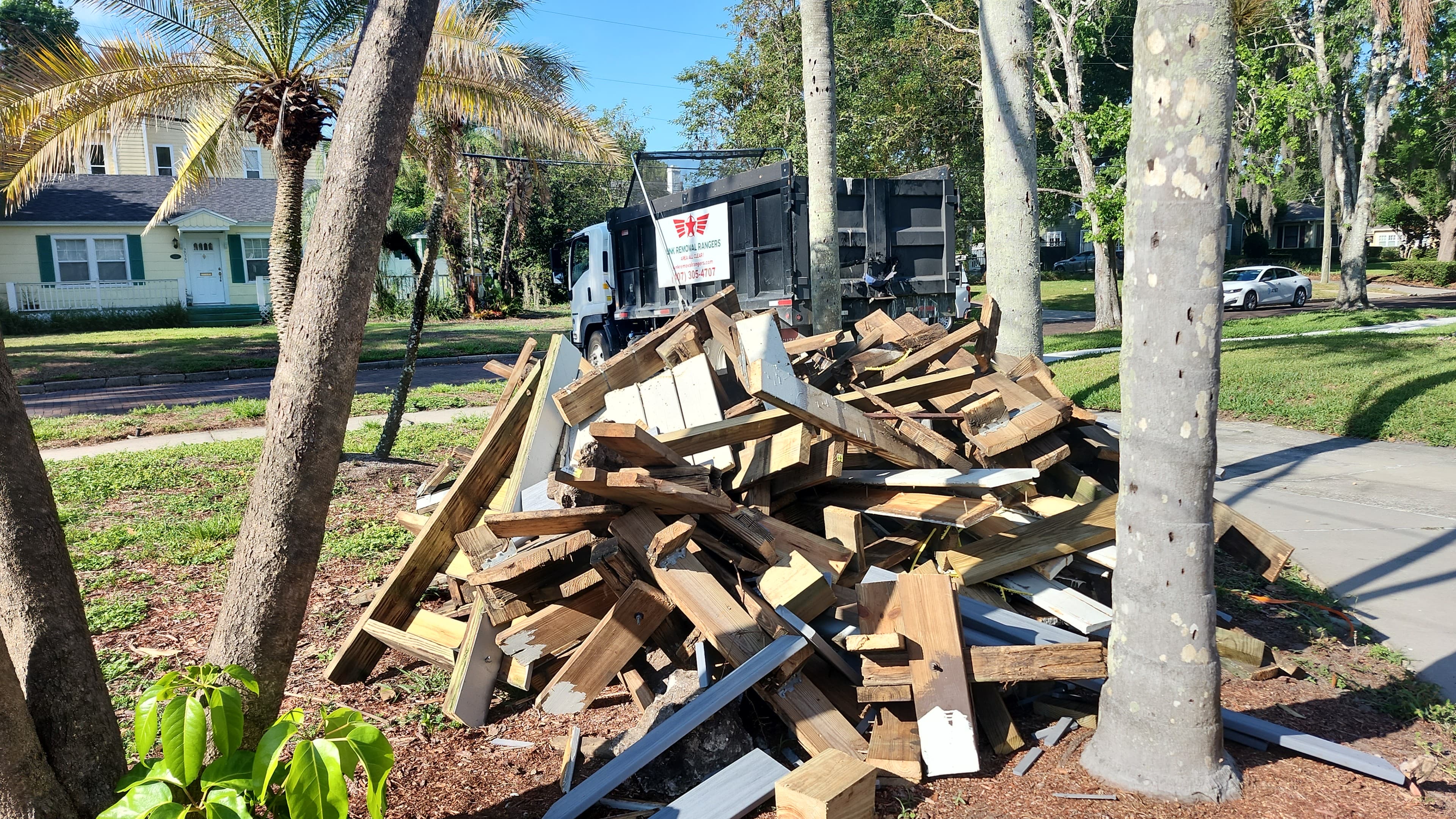 During: Deck debris pile with Junk Removal Rangers truck visible in background during loading